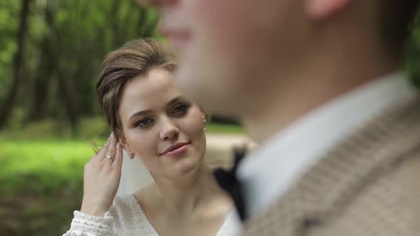 Newlyweds. Caucasian Groom with Bride Walking in Park. Wedding Couple. Man and Woman in Love