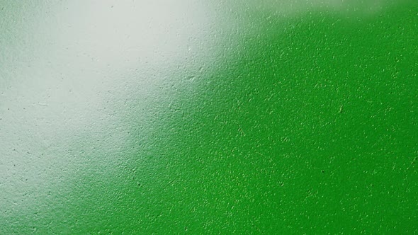 Painting Green Walls with White Paint Using Spray Can Closeup