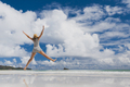 Beautiful woman jumping at the beach - PhotoDune Item for Sale