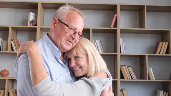 Elderly Couple in Love Slow Dancing at Home