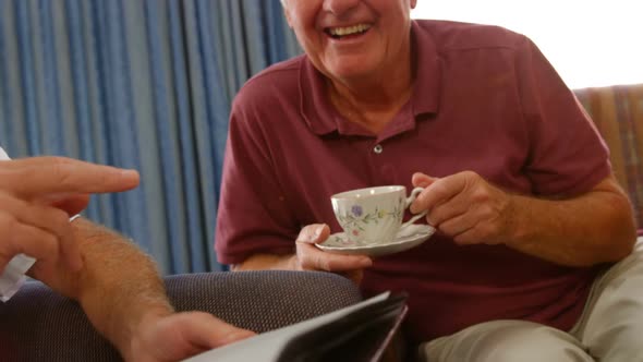 Happy senior friends looking at a photo album