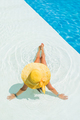 young woman in white hat resting in pool. - PhotoDune Item for Sale