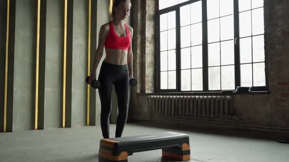 Sporty Woman Practice on Step Platform in Gym