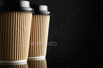 ck lids on reflective table against black wall on the side of a horizontal shot