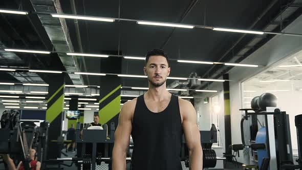 Confident Young Man Looking to the Camera in the Gym