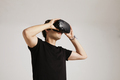 Model in blank black t-shirt putting on VR glasses - PhotoDune Item for Sale