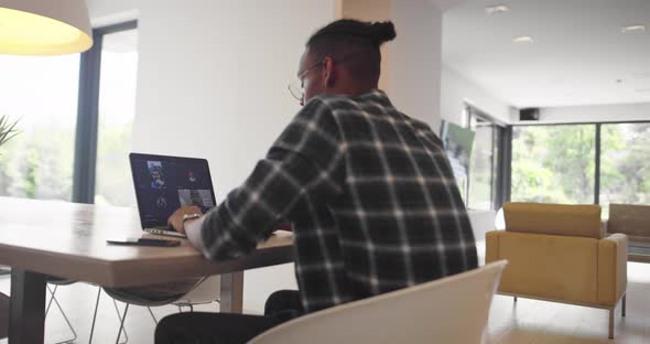 African American Businessman Making Online Conference Video Call Using Smartphone and Laptop