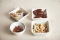 Nuts and dried fruits in small bowls - PhotoDune Item for Sale