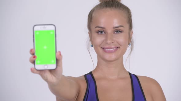 Happy Young Beautiful Blonde Woman Showing Phone