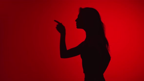 Silhouette of Woman Wagging Index Finger Scolding with Angry Expression