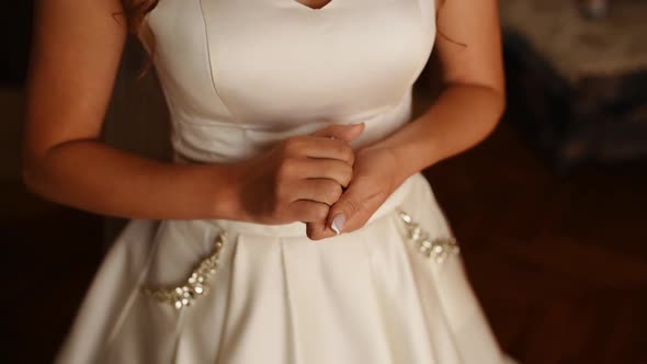 Bride Stands at Window Very Worried Does Not Know What to Do with Her Hands Rubs Them