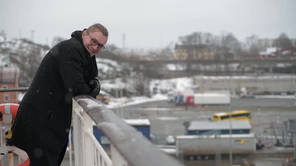 The Person Stands on the Rear Deck of the Ship and Looks at the Winter Landscape