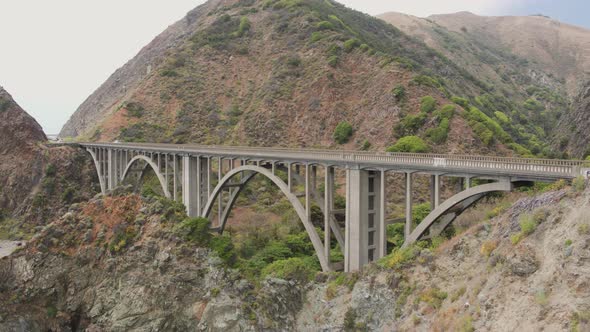 Aerial Drone Shot of a Bridge on a Rocky, Steep Coastline Road (Big Sur, Pacific Coast Highway, cA)