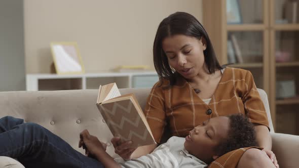 Mother Reading Book to Boy