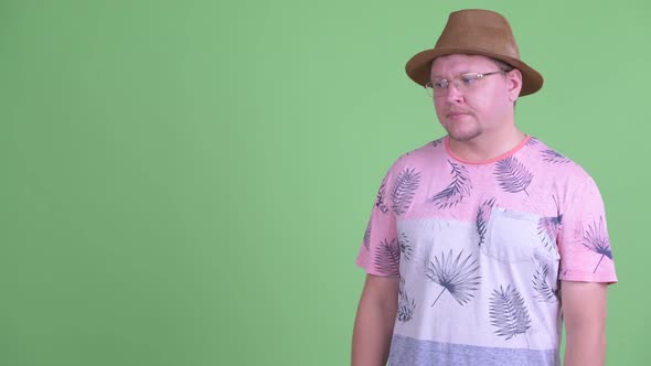 Stressed Overweight Bearded Tourist Man Showing Something