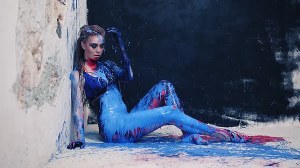 Beautiful Model Splashed with Blue Paint From the Side