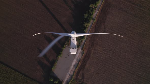 Windmill with huge rotating blades, top view.