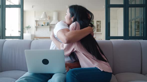 Excited Happy Multiracial Couple Looking at Screen of Laptop Feel Winners Surprised By Lottery