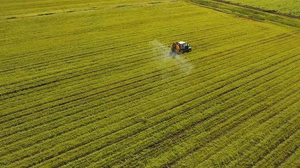 Tractor is Spraying Fertilizers Field