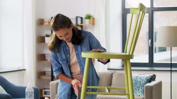 Woman Sanding Old Round Wooden Chair with Sponge