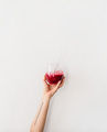 Human hand holding glass with beet pomegranate smoothie, vertical composition - PhotoDune Item for Sale