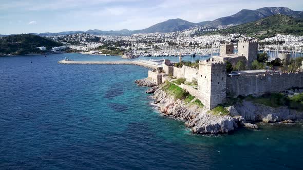 View from drone on full of yachts Bodrum harbour and ancient Kalesi castle in Mugla in Turkey