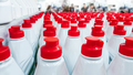 White plastic bottles with red lids in a row. - PhotoDune Item for Sale