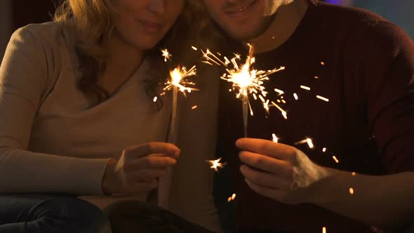 Couple in Love Holding Bengal Lights and Kissing, Celebrating New Year Eve