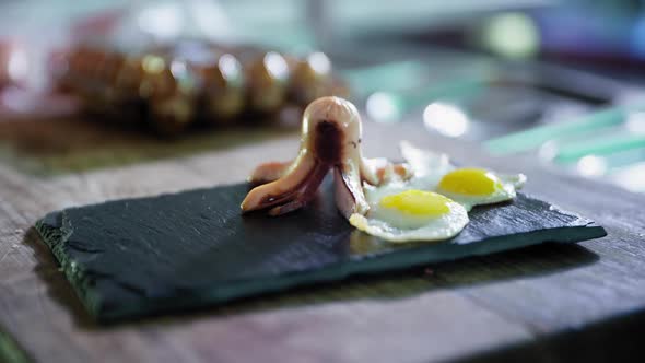 Cooking Breakfast, Chef in Gloves Puts Hot Sausages on Grill on Black Plate with Fried Egg, Proper