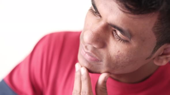 Thoughtful Young Man Sitting on Chair