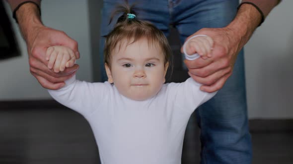 Closeup View of the Baby Girl's Little Girl Taking Her First Steps