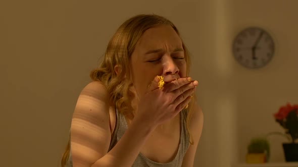 Depressed Teen Girl Greedily Chewing Sweet Cake, Binge Eating Disorder, Bulimia