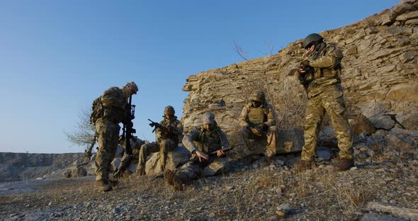 Soldiers Sitting During a Break in an Assault alt