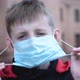 Child Boy Takes Off His Medical Mask Outdoors. - VideoHive Item for Sale
