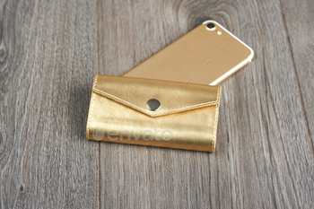 m smooth goldy material and lays on the brown wooden surface near the golden IPhone. Looks very fashionable and stylish.