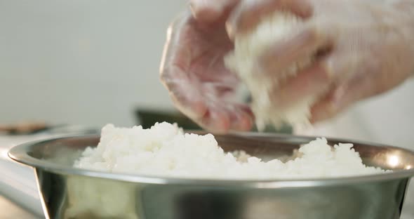 Restaurant Kitchen. Male Sushi Chef Prepares Japanese Sushi Rolls of Rice. Hands Closeup.