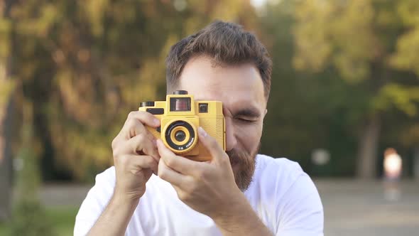 Young, Happy Bearded Man Taking Photos on The Camera