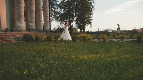 Defile of Lovely Wedding Couple on Track at Ancient Beautiful Castle