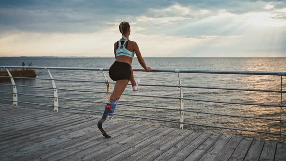 Disabled Girl Working Out on Pier Stretching and Enjoying Seaview