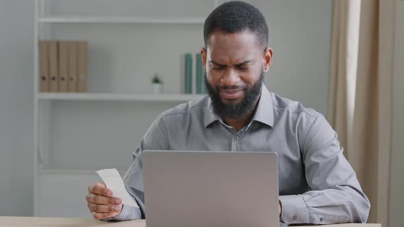 Serious Black Male Accountant Sitting in Home Office Do Work Distantly Managing Company Budget Count
