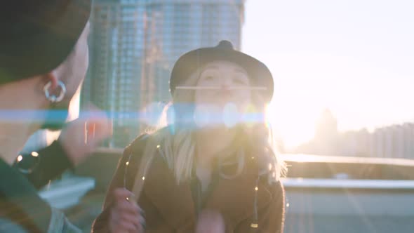 Couple Having Fun and Eating Sushi Outdoors at Sunrise