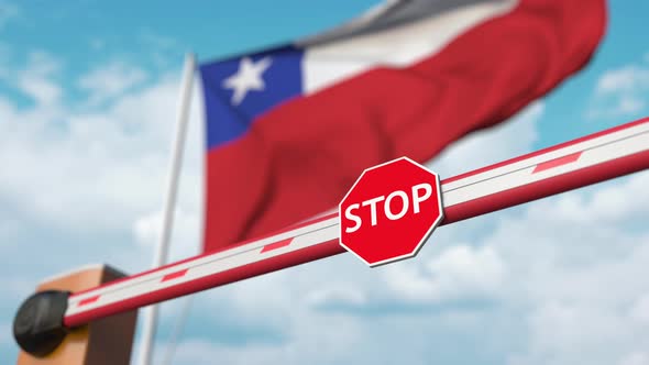 Barrier Gate Being Opened with Flag of Chile As a Background