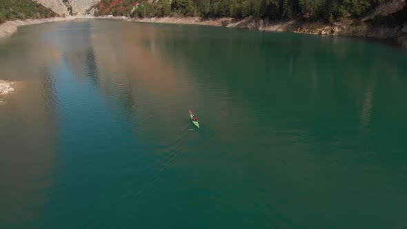 Aerial drone shot following a kayak in the middle of a strait (Congost de Montrebei) Revealing a stu