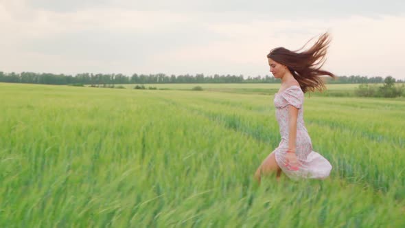 Girl in a White Dress in a Wheat Field at Sunset