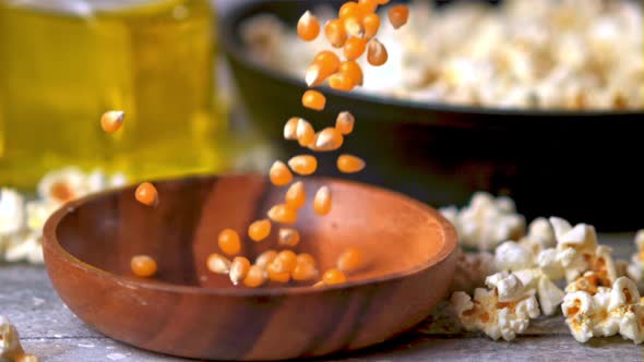 Super Slow Motion Popcorn Grains Fall Into a Wooden Plate