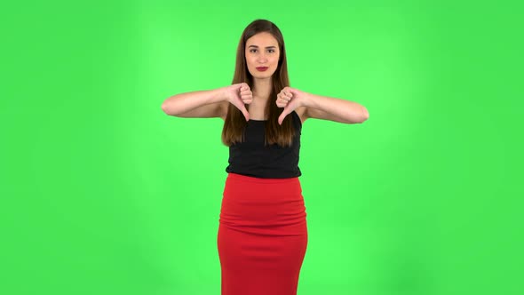 Unhappy Girl Showing Thumbs Down Gesture