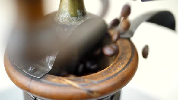 Brown Coffee Beans Falls in Vintage Coffee Grinder