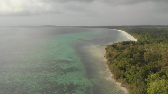 Aerial: uncontaminated coastline tropical beach caribbean sea at Pasir Panjang