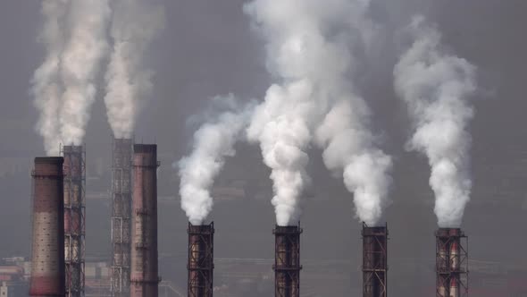 Air pollution by smoke pipes on the background of the city