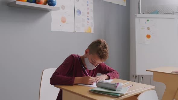 13-Year-Old Boy in Face Mask in Classroom